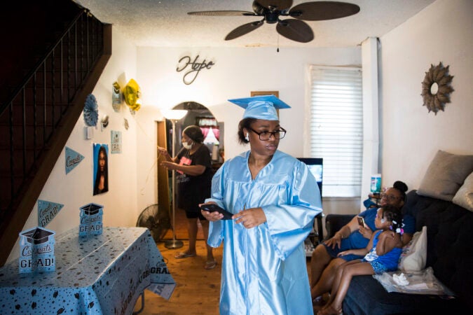 Aliah prepares for Paul Robeson High School's virtual graduation ceremony at her father's house in Grays Ferry on June 10, 2020. (Rachel Wisniewski for Keystone Crossroads)