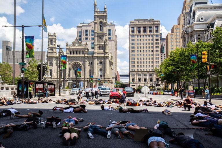 Protesters lay in the intersection of 15th and JFK