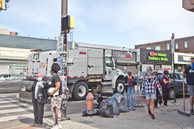 A street sweeper rolls down 52nd Street. (Kimberly Paynter/WHYY)