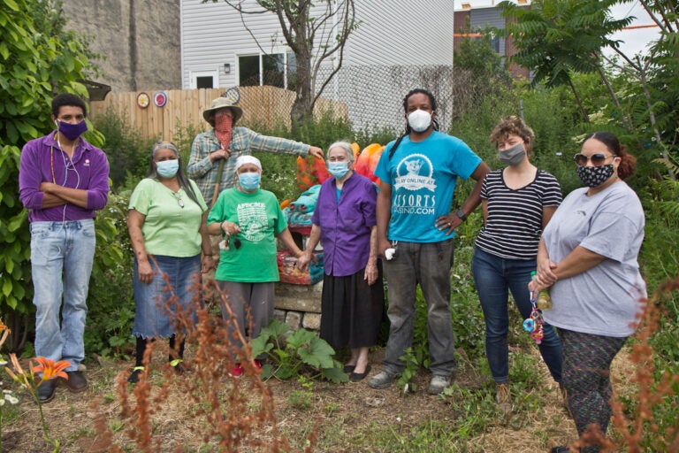 Gardeners (from left) Josh Reaves, Mirta Gonzalez, Sara Vega, Willow Zef, Morgana Ginet, Anthony Batrick, Lauren Troop and Ada Marie Biaz at the César Andreu Iglesias Community Garden in Kensington. (Kimberly Paynter/WHYY)