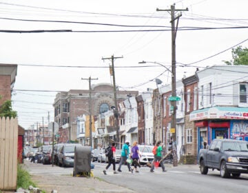 Volunteers brought a broom and cleaning supplies to clear debris left in Kensington. (Kimberly Paynter/WHYY)