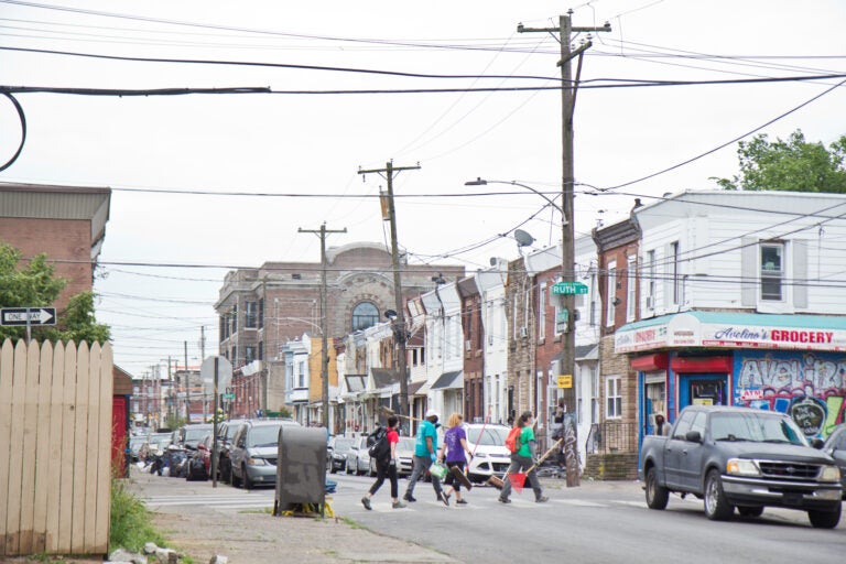 Volunteers brought a broom and cleaning supplies to clear debris left in Kensington. (Kimberly Paynter/WHYY)