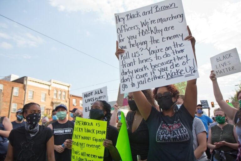 Sharon Horn (right) came to Fishtown from New Jersey to protest a vigilante mob that was in the neighborhood Monday night. (Kimberly Paynter/WHYY)