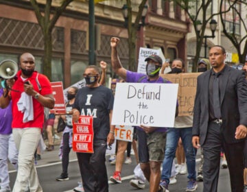 Former Philadelphia Eagles Safety Malcolm Jenkins raised a fist and marched with protesters in Philadelphia. (Kimberly Paynter/WHYY)