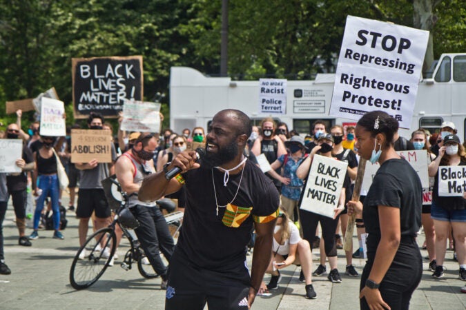 Wallace Weaver of the Do More Campaign called for protesters to become registered voters Saturday afternoon during a mass demonstration at the Philadelphia Art Museum. (Kimberly Paynter/WHYY)