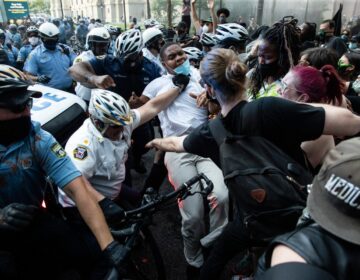 Police and protesters clash Saturday, May 30, 2020, in Philadelphia, during a demonstration over the death of George Floyd. Protests were held throughout the country over the death of Floyd, a black man who died after being restrained by Minneapolis police officers on May 25. (AP Photo/Matt Rourke)