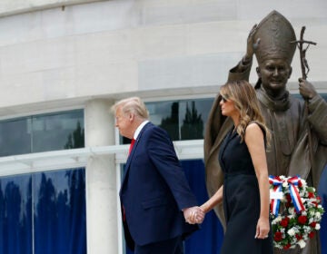 President Donald Trump holds first lady Melania Trump's hand as they visit Saint John Paul II National Shrine, Tuesday, June 2, 2020, in Washington. (AP Photo/Patrick Semansky)