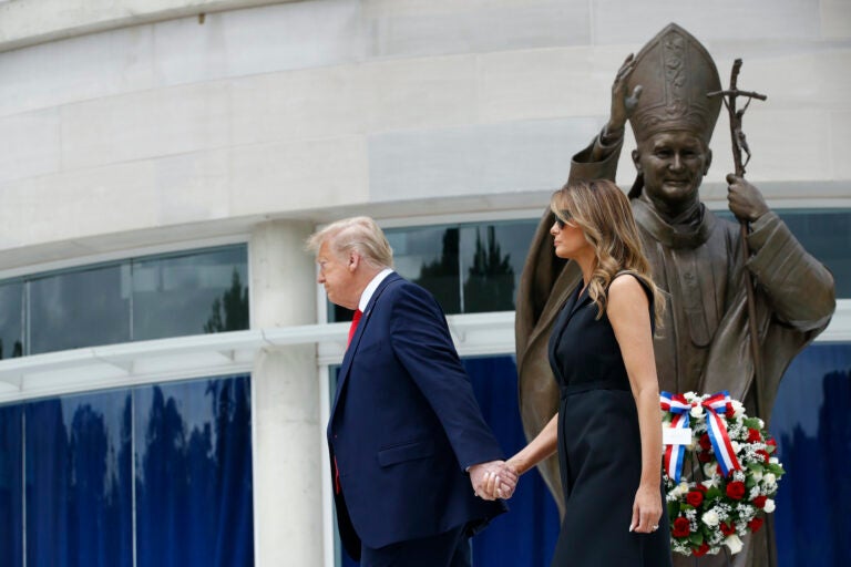 President Donald Trump holds first lady Melania Trump's hand as they visit Saint John Paul II National Shrine, Tuesday, June 2, 2020, in Washington. (AP Photo/Patrick Semansky)