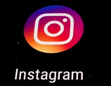 FILE - In this Nov. 29, 2018 file photo, the Instagram app logo is displayed on a mobile screen in Los Angeles. Though Black Out Tuesday was originally organized by the music community, the social media world went dark on Tuesday in support of the Black Lives Matter movement and the many killings of black people around the world that has caused outrage and protests. Instagram accounts, from top record label to everyday people, was full of black squares posted in response to the deaths of George Floyd, Ahmaud Arbery and Breonna Taylor. (AP Photo/Damian Dovarganes, File)