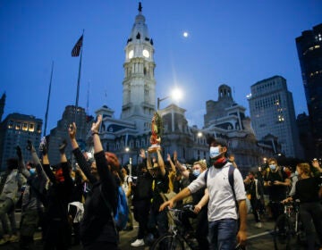 Demonstrators march Tuesday, June 2, 2020, near City Hall in Philadelphia, during a protest over the death of George Floyd, who died May 25 after he was restrained by Minneapolis police. (AP Photo/Matt Rourke)