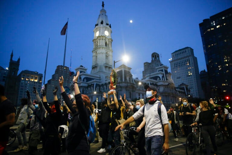 Demonstrators march Tuesday, June 2, 2020, near City Hall in Philadelphia, during a protest over the death of George Floyd, who died May 25 after he was restrained by Minneapolis police. (AP Photo/Matt Rourke)