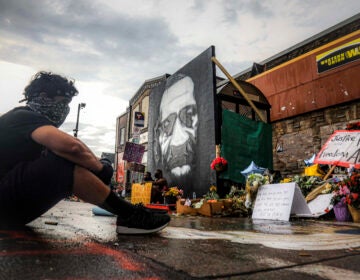 Trevor Rodriquez sits alone at the spot where Floyd died at the hands of police