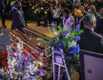 Members of the Congressional Black Caucus, at right, including Rep. Sheila Jackson-Lee, left, wearing blue face mask, U.S. Rep. Ilhan Omar, second from left, and U.S. Rep. Ayanna Pressley, right, stand at the casket of George Floyd before a memorial service at North Central University, Thursday, June 4, 2020, in Minneapolis. (Bebeto Matthews/AP Photo)