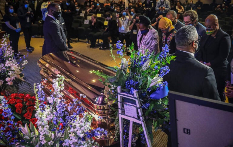 Members of the Congressional Black Caucus, at right, including Rep. Sheila Jackson-Lee, left, wearing blue face mask, U.S. Rep. Ilhan Omar, second from left, and U.S. Rep. Ayanna Pressley, right, stand at the casket of George Floyd before a memorial service at North Central University, Thursday, June 4, 2020, in Minneapolis. (Bebeto Matthews/AP Photo)