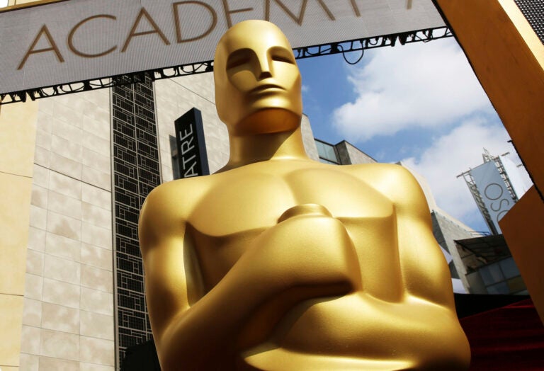 A close-up of an Oscar statue outside of the Dolby Theatre is shown.