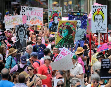 In this June 30, 2019, file photo, marchers carry signs with historical LGBTQ figures during the Queer Liberation March in New York. (AP Photo/Seth Wenig, File)