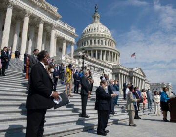 Rep. Karen Bass, D-Calif., joined by House Speaker Nancy Pelosi of Calif., and other House Democrats spaced for social distancing, speaks during a news conference on the House East Front Steps on Capitol Hill in Washington, Thursday, June 25, 2020, ahead of the House vote on the George Floyd Justice in Policing Act of 2020. (AP Photo/Carolyn Kaster)