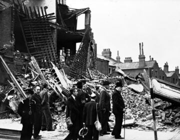 Britain's Prime Minister Winston Churchill, right, accompanied by officials, inspects the damage caused by German bombs in London's East End, Sept. 9, 1940, during the Blitz.  (AP Photo/British Official Photo)