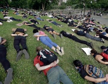 Demonstrators lie face down depicting George Floyd during his detention by police