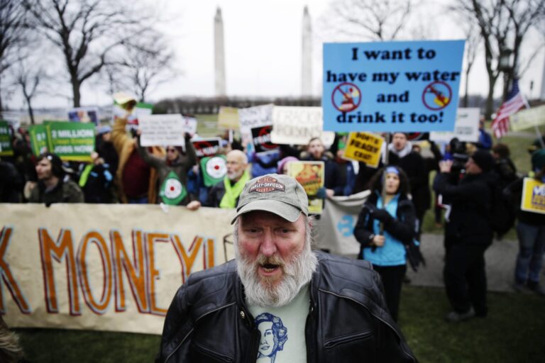Hydraulic fracturing opponents, including Ray Kemble of Dimock, Pa., front, demonstrate before Gov, -elect Tom Wolf takes the oath of office to become the 47th governor of Pennsylvania, Tuesday, Jan. 20, 2015, at the state Capitol. (Matt Rourke / Associated Press)