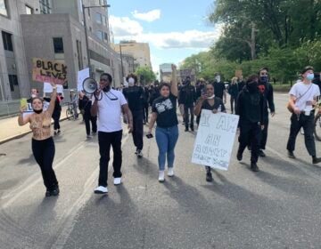 Protesters march past Philadelphia Police Department headquarters on Sunday, May 31, 2020. (Chris Norris/WHYY)