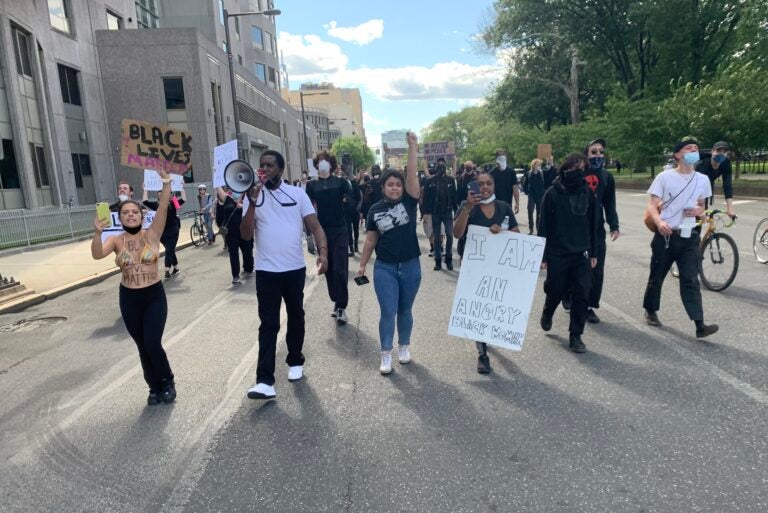 Protesters march past Philadelphia Police Department headquarters on Sunday, May 31, 2020. (Chris Norris/WHYY)