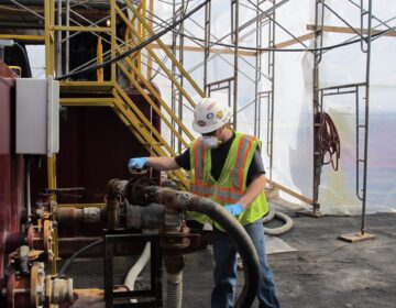 A worker operates valves at a frack water recycling plant used by Cabot Oil and Gas. (StateImpact Pennsylvania)