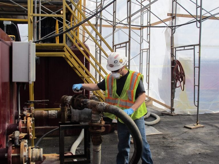 A worker operates valves at a frack water recycling plant used by Cabot Oil and Gas. (StateImpact Pennsylvania)