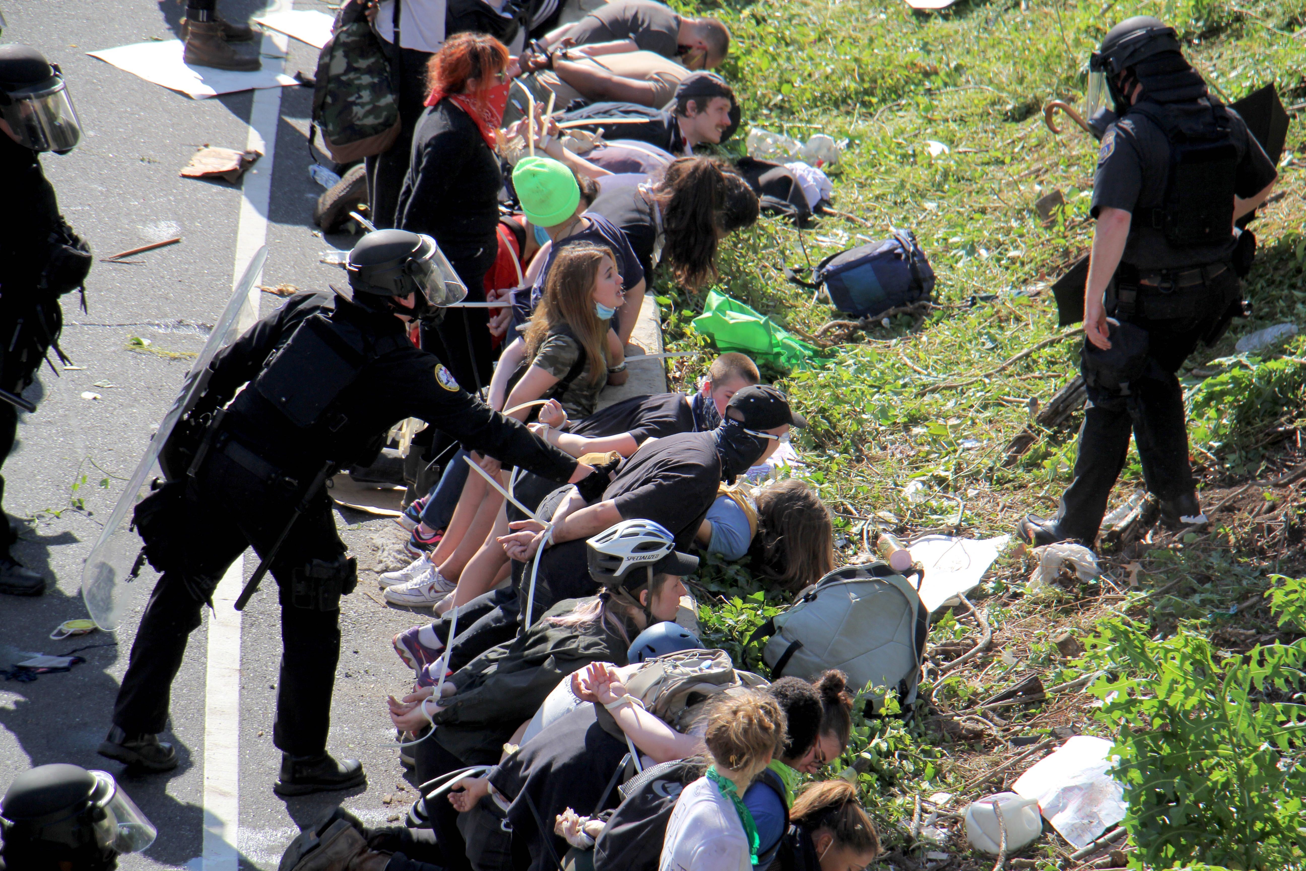 Police arrest dozens of protesters on Route 676 near 21st Street after they blocked traffic.