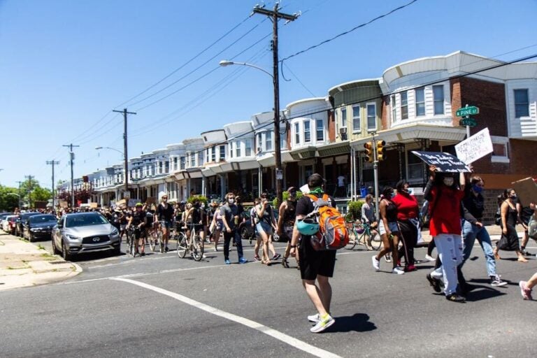 Protesters in West Philadelphia marched from the site of the MOVE bombing to Malcolm X park in protest of racial injustice. (Kimberly Paynter/WHYY)