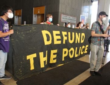 Protesters at the Philadelphia Municipal Services Building demand the resignation of city Managing Director Brian Abernathy. (Emma lee/WHYY)