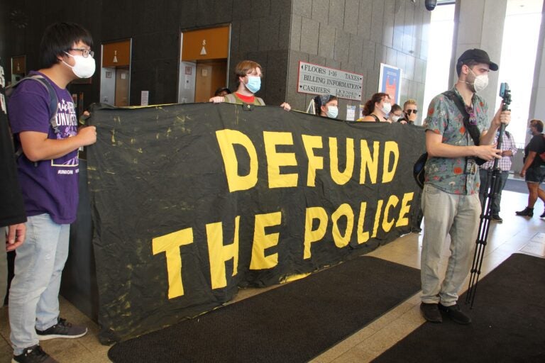 Protesters at the Philadelphia Municipal Services Building demand the resignation of city Managing Director Brian Abernathy. (Emma lee/WHYY)