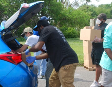 Volunteers load food boxes into cars during a food distribution by the Food Bank of South Jersey in Riverside, Burlington County on June 6. (Jon Hurdle/NJ Spotlight)
