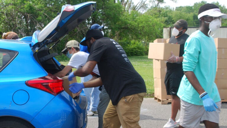 Volunteers load food boxes into cars during a food distribution by the Food Bank of South Jersey in Riverside, Burlington County on June 6. (Jon Hurdle/NJ Spotlight)