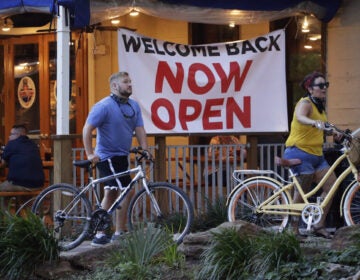 Visitors to the River Walk pass a restaurant that has reopened in San Antonio, Texas, on May 27. Texas continues to reopen in the wake of the COVID-19 pandemic.
