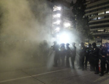 Police officers fire rubber bullets May 29 during a Los Angeles protest over the death of George Floyd. (Ringo H.W. Chiu/AP Photo)