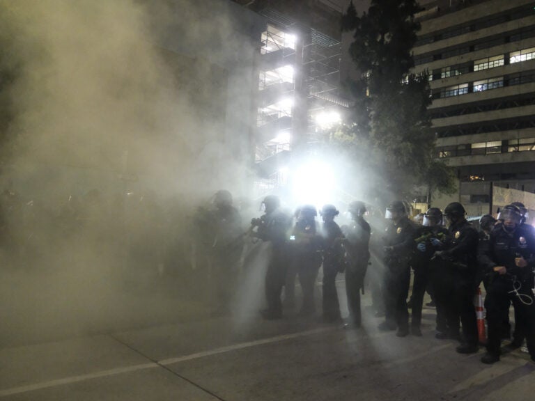 Police officers fire rubber bullets May 29 during a Los Angeles protest over the death of George Floyd. (Ringo H.W. Chiu/AP Photo)