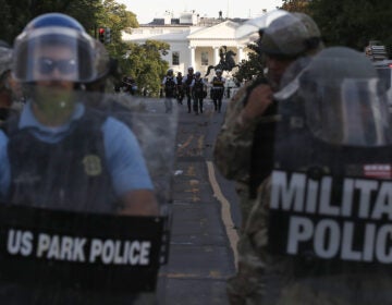Authorities clear Lafayette Park in Washington, D.C., on Monday, while across the street at the White House, President Trump said he would send the military to U.S. cities if local officials don't end unrest. (Alex Brandon/AP Photo)