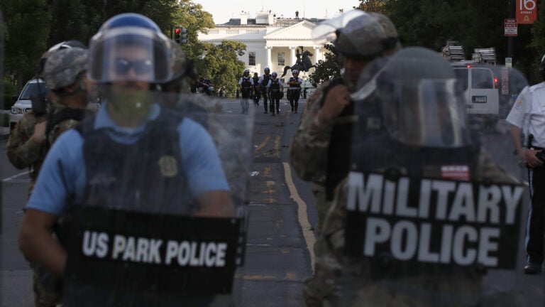 Authorities clear Lafayette Park in Washington, D.C., on Monday, while across the street at the White House, President Trump said he would send the military to U.S. cities if local officials don't end unrest. (Alex Brandon/AP Photo)