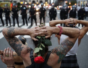 Protesters kneel in front of New York City police officers