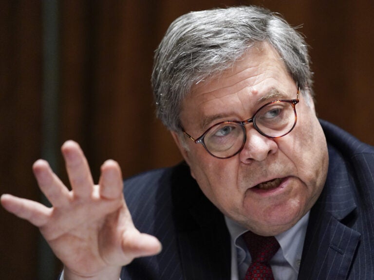 Critics have called Attorney General William Barr too willing to do the bidding of President Trump. Justice Department attorneys say they've seen political pressure in big cases.
Evan Vucci/AP