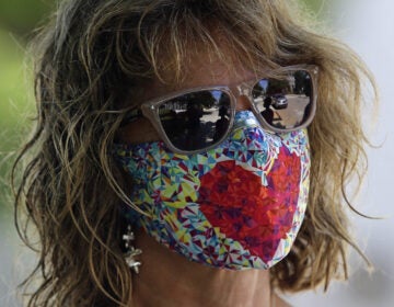 The Department of Justice has issued an alert about a card circulating online falsely claiming that holders are legally exempt from wearing a mask. Public health officials overwhelmingly recommend wearing a mask when going out in public. (Gerry Broome/AP Photo)