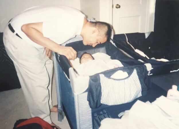 Johnny Acevedo looks over Ashley as an infant. (Photo courtesy of the Acevedo family)