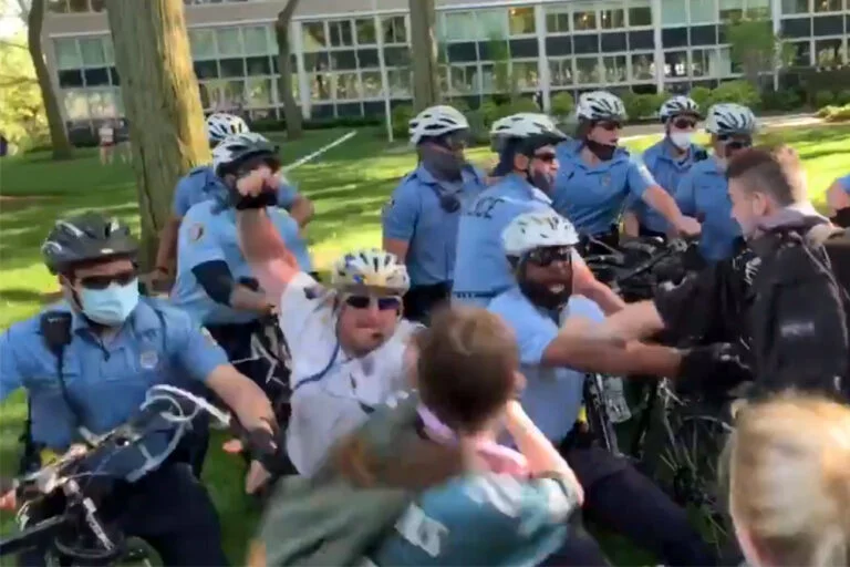 Former Philadelphia Police Staff Inspector Joseph Bologna (center) is seen striking a protester with a baton during a protest.