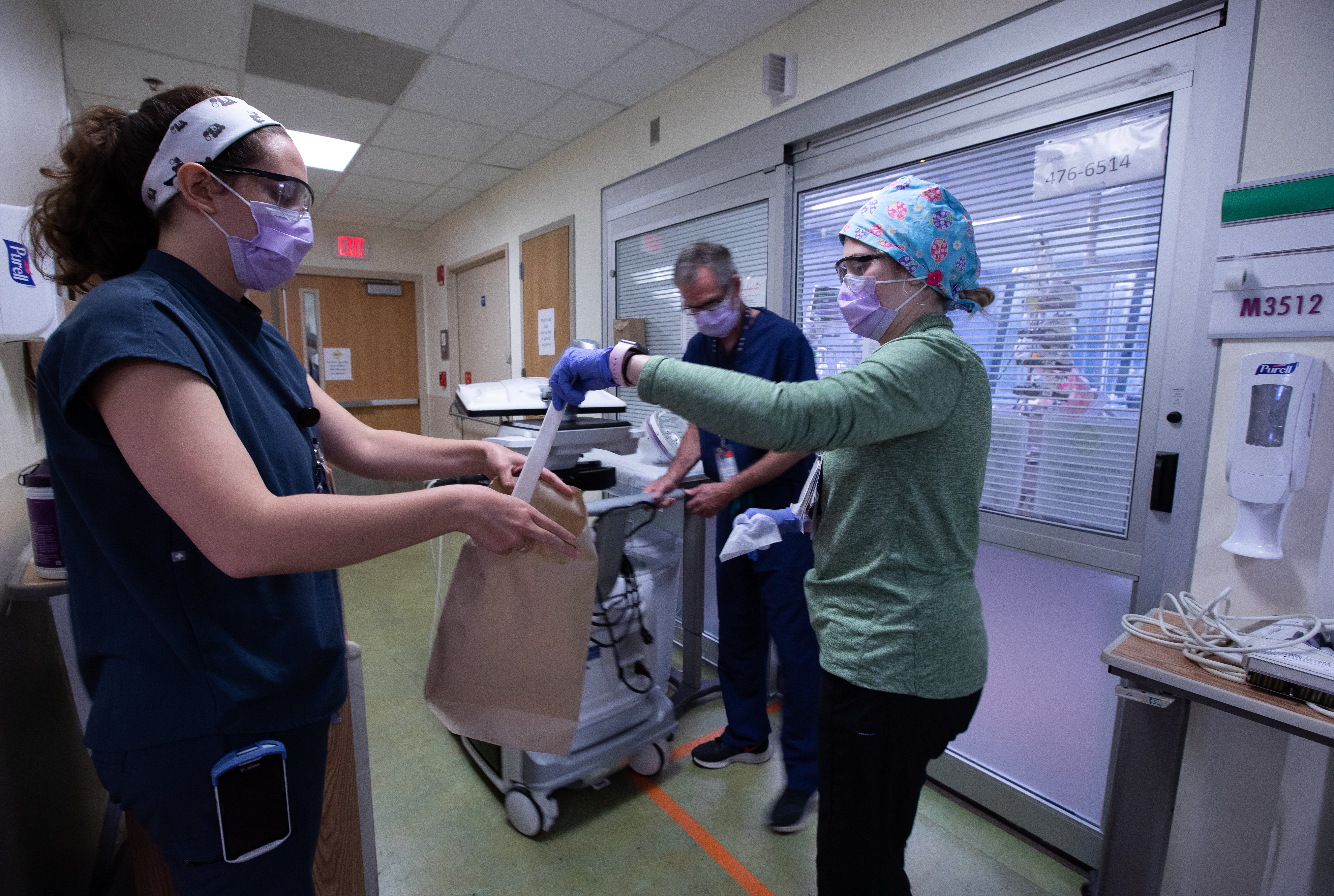 Nurses from the pediatric intensive care unit put away protective equipment in order to sanitize it after being used by a staff member at the Children's National Hospital.