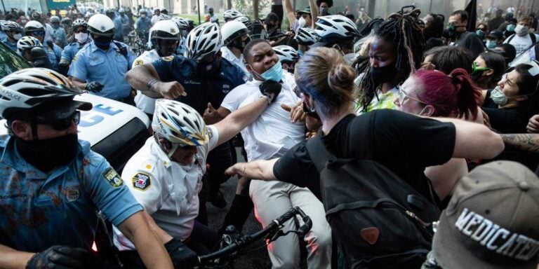 Police and protesters clash Saturday, May 30, 2020, in Philadelphia, during a demonstration over the death of George Floyd. Protests were held throughout the country over the death of Floyd, a black man who died after being restrained by Minneapolis police officers on May 25. (AP Photo/Matt Rourke)