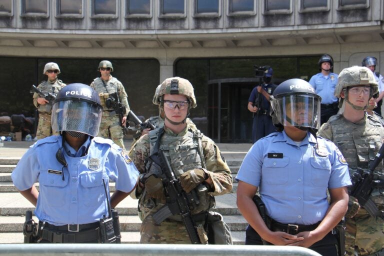 File - National guard troops help protect Philadelphia police headquarters during a series of protests aimed at police brutality. (Emma Lee/WHYY)