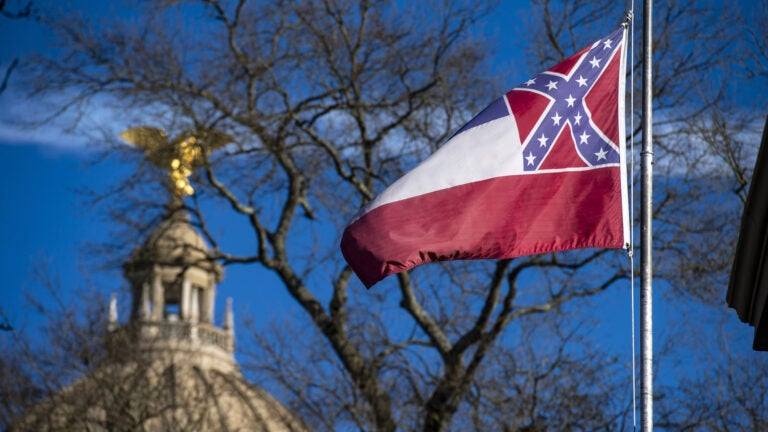 The flag of the state of Mississippi flies in front of the Mississippi State Capitol dome on Jan. 10, 2019. Lawmakers have voted to remove and replace the flag.