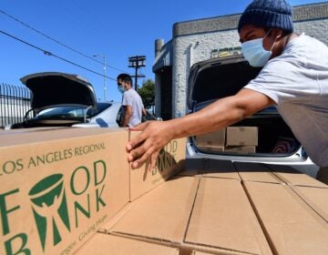 Boxes of food at are loaded at the Los Angeles Regional Food Bank on May 5. The country has officially entered a recession amid the pandemic, the National Bureau of Economic Research said Monday.