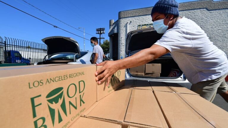 Boxes of food at are loaded at the Los Angeles Regional Food Bank on May 5. The country has officially entered a recession amid the pandemic, the National Bureau of Economic Research said Monday.